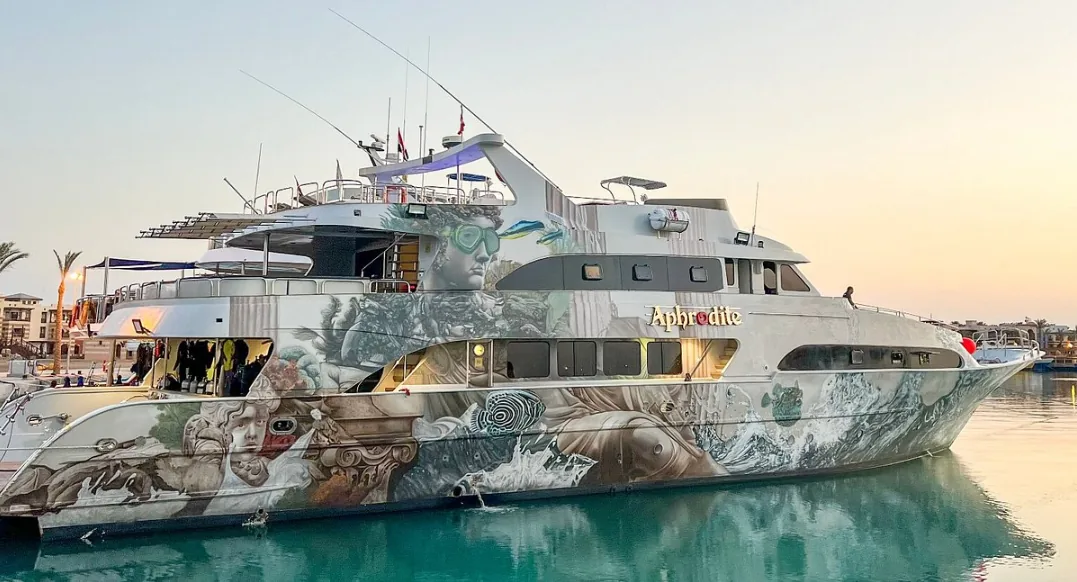The Aphrodite safari vessel, with its distinctive mural hull art, moored at Hurghada Marina.