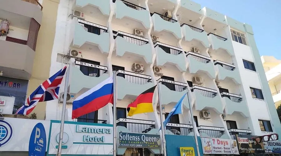 Lamera Hotel's facade, flying UK, Russian, German and UN flags.
