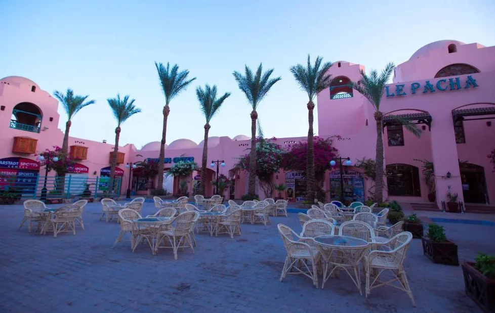 Le Pacha Resort's courtyard and shopping arcade at dusk.